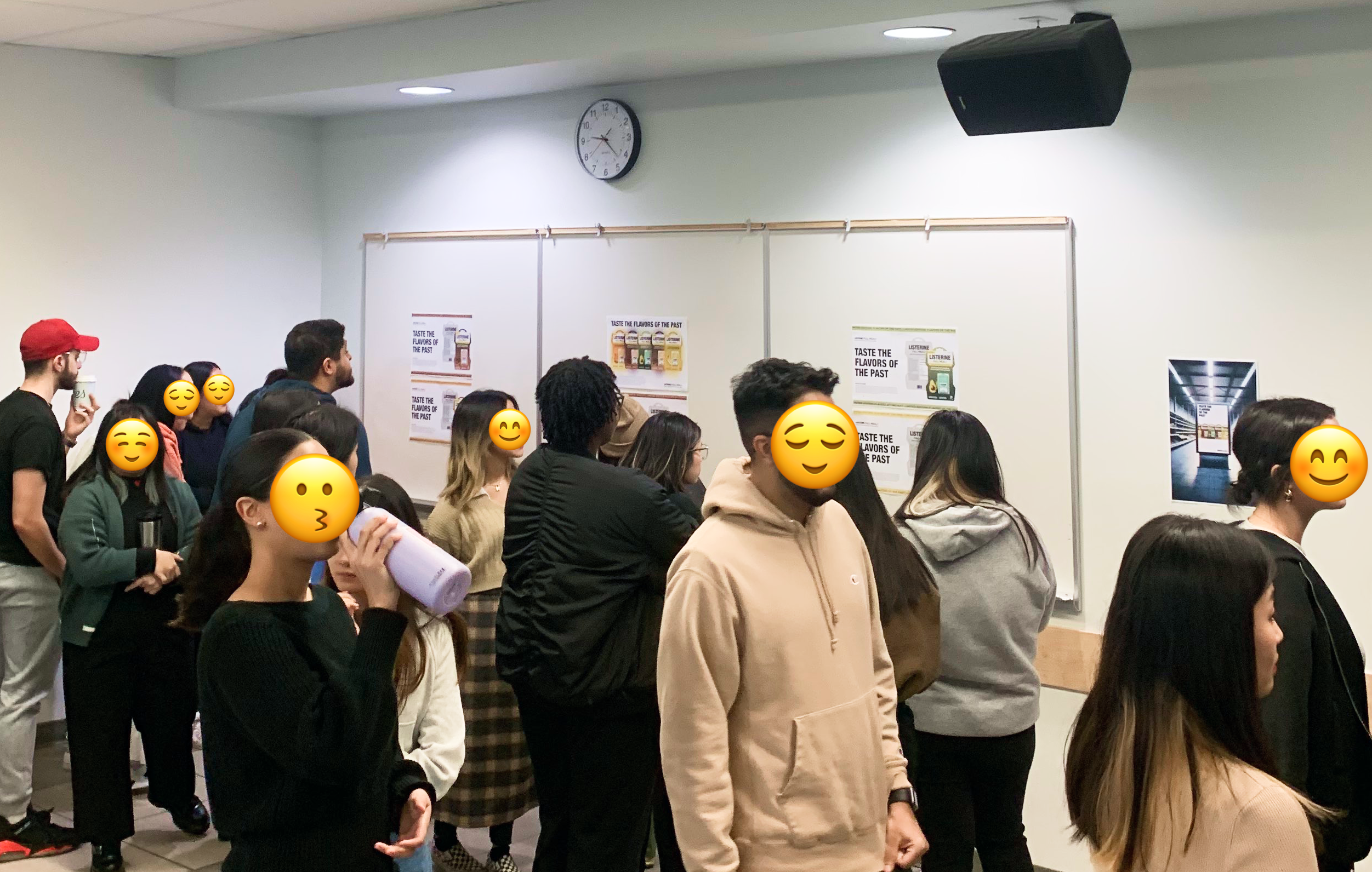 classmates observing the listerine posters during peer critic session